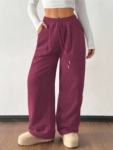 Detail of elastic waistband and drawstring on pink corduroy wide-leg casual pants