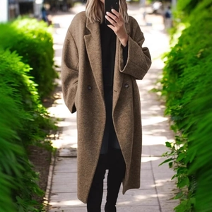 Detail of dark brown oversized wool blend long coat with a classic notched lapel collar