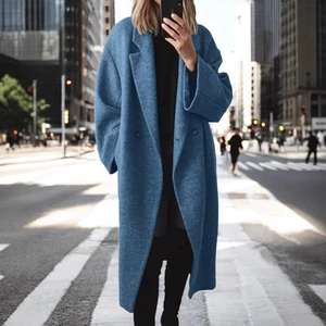 Gros plan d'un manteau long bleu ciel en laine avec revers et boutons décoratifs