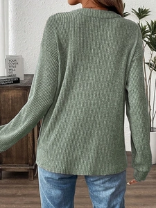 Rear view of women's loose-fit ribbed knit long sleeve T-shirt in grass green color