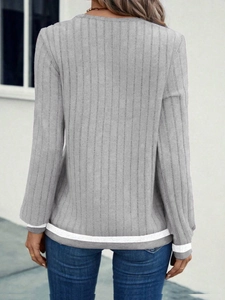 Detail view of the back of a grey ribbed long-sleeved top showing the fitted knit texture