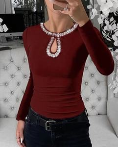 Detail of burgundy ribbed long-sleeve top with rhinestone keyhole neckline cutout