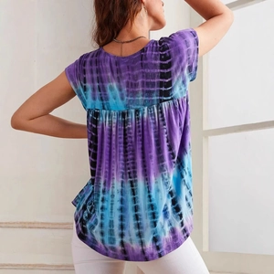 Detailed back view of tie-dye short sleeve top featuring artistic pleats and purple-blue textures