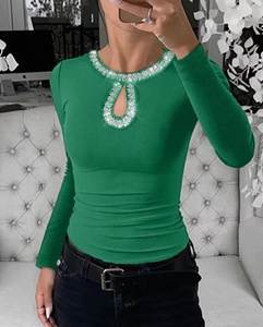 Close-up of emerald green ribbed long sleeve top with rhinestone cutout neckline detail