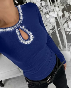 Detail of teardrop cutout neckline with silver rhinestones on navy ribbed knit top