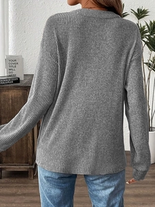 Rear view of grey ribbed long sleeve knit top with button detail and loose fit
