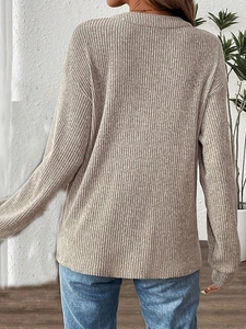 Rear view of oatmeal ribbed knit long sleeve tee with loose fit and textured fabric
