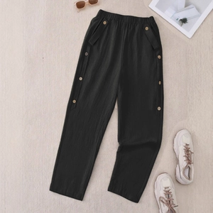 Retro loose black casual pants with elastic waist and decorative side wood buttons