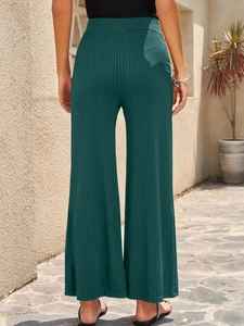 Macro shot of dark green high-waisted wide-leg trousers in breathable ribbed texture fabric
