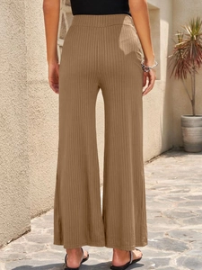 Close-up of the high waist elastic waistband on light brown ribbed wide leg pants