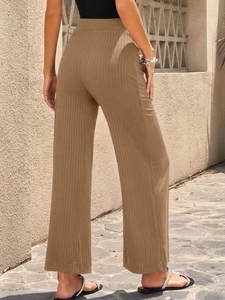 Close-up of khaki high-waisted wide-leg pants featuring vertical ribbed texture
