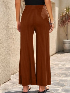 Back view of high-waisted ribbed wide-leg pants in caramel brown with natural drape