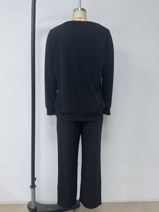 Detail view of the black long-sleeve top and wide-leg trousers casual lounge set from the back