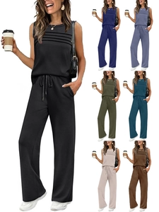 Detail of a two-piece casual set with sleeveless pleated top and wide-leg trousers