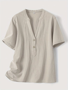 Close-up of beige cotton linen blend shirt with V-neckline and button details