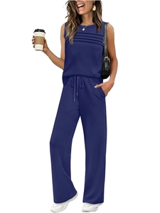 Detail of the navy blue sleeveless top featuring stylish horizontal pleats and high-quality fabric