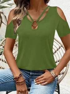 Detalle de camiseta verde aguacate con hombros descubiertos, tiras cruzadas y aro dorado