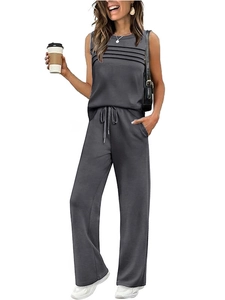 Detail of grey sleeveless two-piece set featuring pleated top and drawstring wide-leg pants