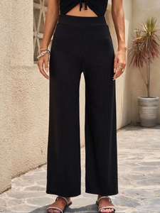 Pantalones negros de talle alto y pernera ancha para mujer en punto de canalé elástico