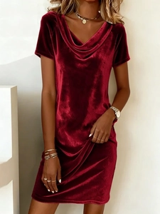 Detailed close-up of burgundy velvet dress cowl neck texture and elegant fabric sheen