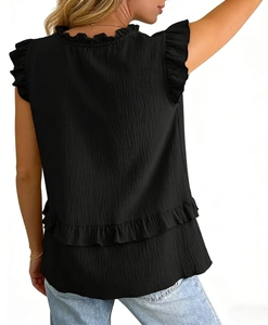 Detail of black ruffled sleeveless top featuring pleated texture and layered hem design