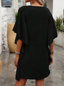 Back view of black summer dress with ruffled sleeves and textured cotton fabric