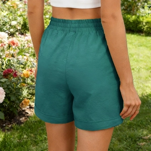 Back view of dark green high waisted casual shorts featuring an elastic drawstring waistband