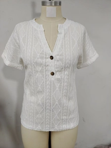 Detail view of white V-neck T-shirt showing texture, buttons and rolled cuffs