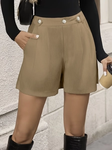 Close-up of khaki corduroy shorts featuring high waist and three silver decorative buttons
