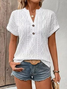 Detailed close-up of white V-neck knit top with hollow geometric diamond patterns