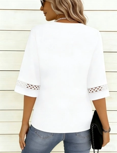 Detailed view of the delicate circular hollow lace stitching on the white t-shirt sleeve