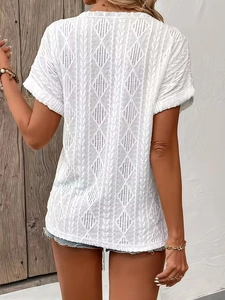 Detail of white knit t-shirt featuring intricate diamond cutout patterns and back texture
