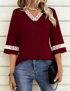 Close-up of wine red V-neck T-shirt with white circular hollow lace trim detailing
