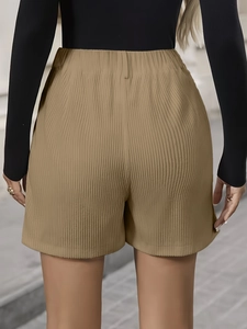 Close-up of khaki wide-leg corduroy shorts featuring elastic high waist and vertical texture
