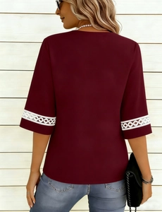 Detail of wine red t-shirt with white circular geometric lace trim on short sleeves