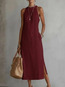 Detail of wine red maxi dress featuring hollow lace splicing and side slit hem