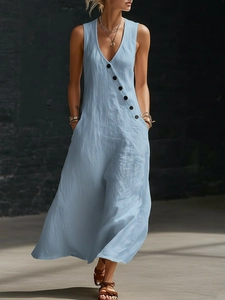 Detailed texture of light blue cotton linen dress with V-neck and decorative black buttons