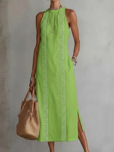 Detail of green summer halter maxi dress with white geometric embroidery and side slits