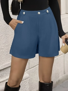 Detail of blue high-waisted corduroy shorts with vintage buttons and side pockets