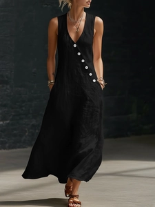Detail of a black cotton linen maxi dress featuring diagonal white button decoration