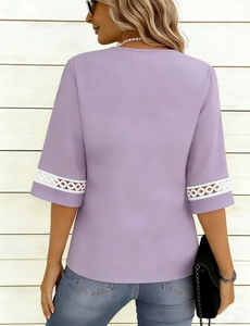 Detailed back view of purple short-sleeved top with white lace patchwork on cuffs