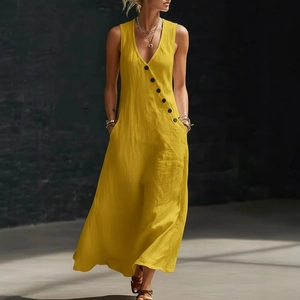 Detailed close-up of yellow cotton linen V-neck dress with diagonal black buttons