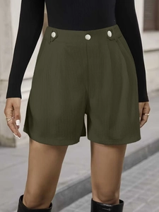 Detailed macro of army green high-waisted corduroy shorts with silver metal buckle accents