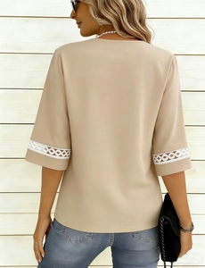 Detail of beige summer top featuring delicate white lace trim on sleeves with denim styling