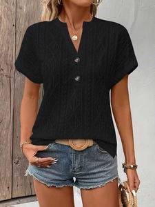 Close-up of black V-neck knitted t-shirt with intricate texture and button detail