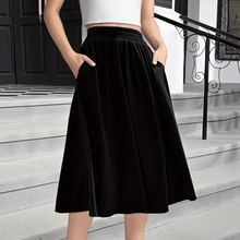 Detail of high-waist black velvet A-line midi skirt with functional side pockets
