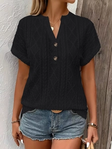 Detail of black knit V-neck tee with button accents and textured diamond pattern