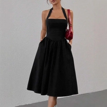 Detail of elegant black halter dress with square neck and flattering cinched waistline