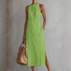 Bright green halter maxi dress with white geometric patterns and side slit detail