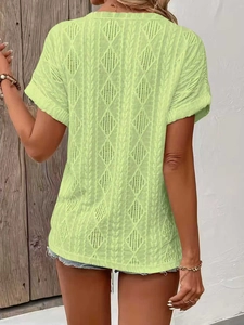 Rear view of grass green short sleeve knit top with intricate hollow crochet textures